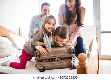 Young family with two children packing for holiday.