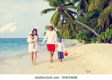 Young Family With Two Kids Walking At Tropical Beach, Family Beach Vacation