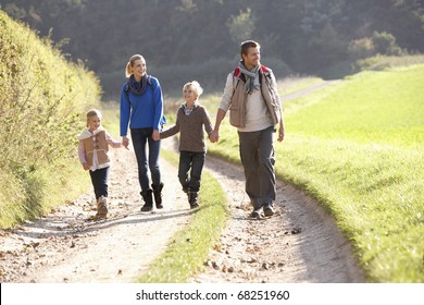 Young Family Walking In Park