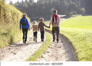 Young Family Walking In Park