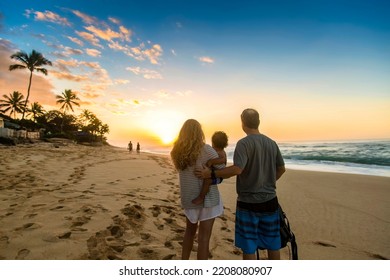 Young family watching a beautiful ocean sunset together at Sunset Beach, Oahu, Hawaii. Beautiful scenic view on a Hawaiian beach. Family moments together - Powered by Shutterstock