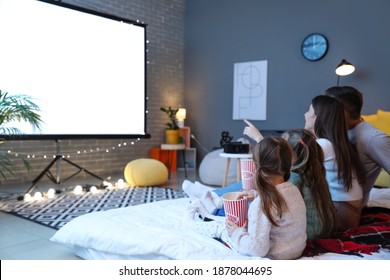 Young family watching movie at home