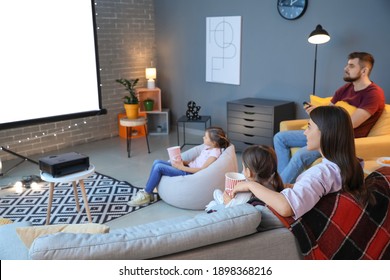 Young Family Watching Movie At Home