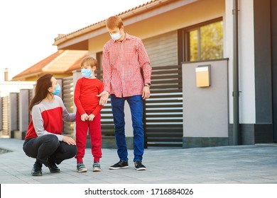 Young Family Wearing Face Mask Outdoors. Prevention Coronavirus. Son With Parents Going For A Walk. New Real Life. Fight Coronavirus. Safety Mask To Protect Coronavirus Outbreak. Quarantine.