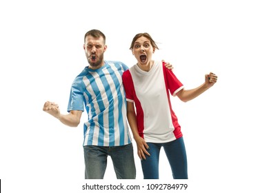 The young fans celebrating on white background. The young man in soccer football uniform and girl as winner isolated at white studio. Fan, support concept. Human emotions concept. - Powered by Shutterstock