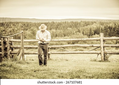 Young Farmer And A Chicken At The Farm