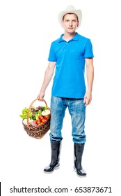 Young Farmer Portrait With A Basket Of Vegetables On A White Background In Full Length