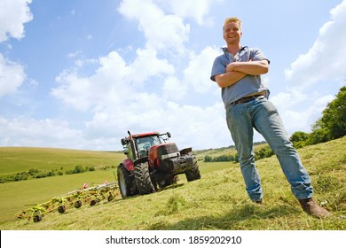 Young Farmer And Tractor In Field