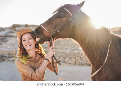 Young Farmer Woman Playing With Her Horse In A Sunny Day Inside Corral Ranch - Concept About Love Between People And Animals - Focus On Girl Face