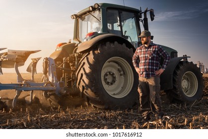 Young Farmer Working During The Tractor Plowing Fields -preparing Land For Sowing