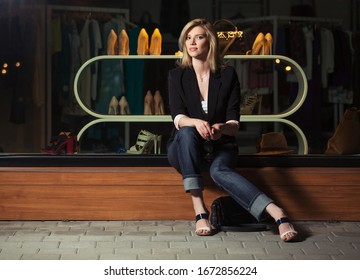 Young Fashion Blond Business Woman Sitting On The Mall Window Stylish Female Model In Black Blazer