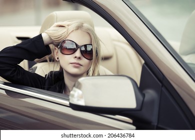 Young Fashion Blond Woman Driving Convertible Car 