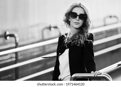 Young Fashion Blonde Business Woman Leaning On Railing Stylish Female Model In Black Jacket And Sunglasses 