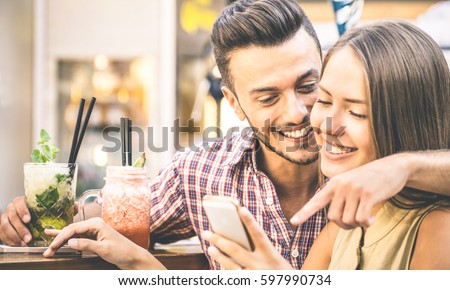 Similar – Image, Stock Photo Romantic moment with a couple sharing a strawberry on a rooftop