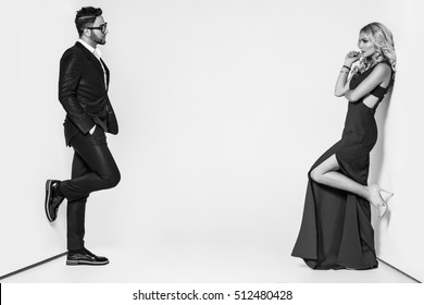 Young Fashion Couple On A White Background In Studio