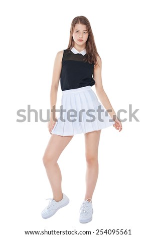Young fashion girl in white skirt posing isolated on white background