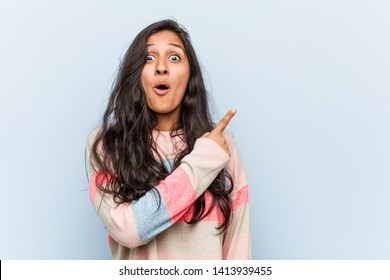 Young fashion indian woman pointing to the side