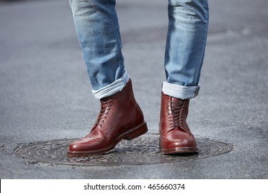 Young Fashion Man's Legs In Blue Denim Jeans And Brown Boots.