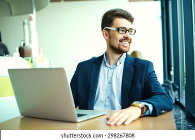 Young fashion smiling hipster man  in the city cafe during lunch time with notebook in suit  - Shutterstock ID 298267808