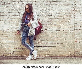 Young Fashion Woman Flirting On The Background Of Old Brick Wall. Outdoors, Lifestyle.