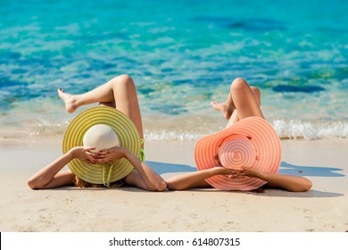 Young fashion woman relax on the beach. Happy island lifestyle. White sand, blue cloudy sky and crystal sea of tropical beach. Vacation at Paradise. Ocean beach relax, travel to Maldives islands