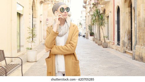 Young Fashionable Caucasian Girl Walking On Italian Street, Speaking By Mobile Phone.