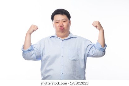 Young Fat Asian Business Man Showing Strenght And Looking To Camera Isolated On White Background.