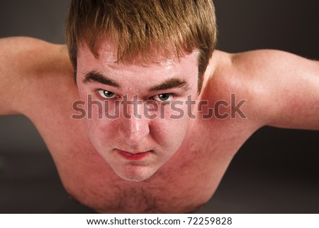 Young fat man doing push up exercise