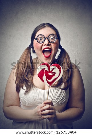 young fat woman surprised with glasses and lollipop
