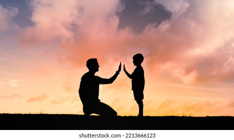 Young father giving his little boy son high-five encouragement. Parenting and childcare concept.  - Powered by Shutterstock