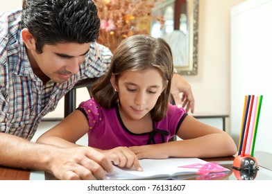 Young Father Helping Her Daughter With Her School Project At Home