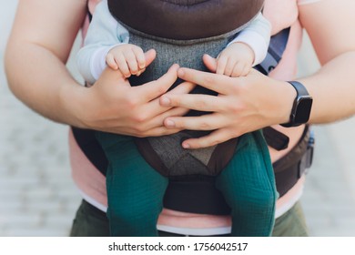 Young Father And His Baby Girl In A Baby Carrier.