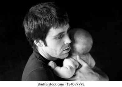 Young Father With His Crying Baby In Studio