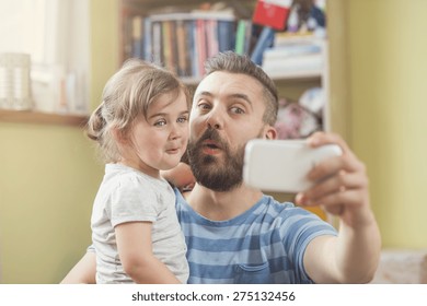 Young father with his cute little daughter taking selfie - Powered by Shutterstock