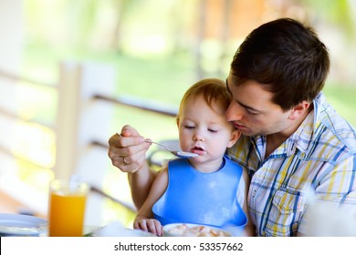 Young  father and his daughter having breakfast together - Powered by Shutterstock