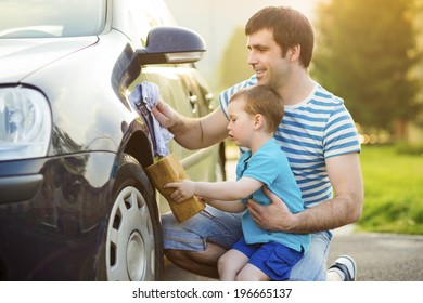 Young Father With His Little Son Washing Car