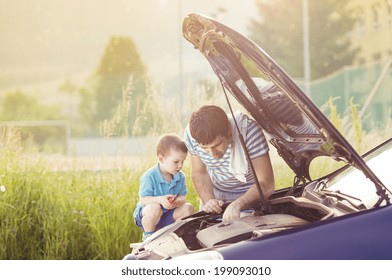 Young Father With His Little Son Repairing Car