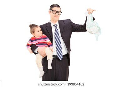 Young Father Holding A Baby And A Dirty Diaper Isolated On White Background