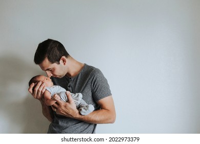 Young Father Holding His Baby