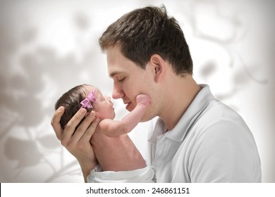 Young Father Is Holding His Newborn Baby Girl