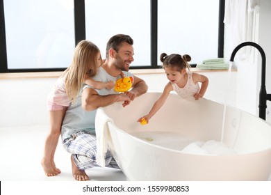 Young father with little daughters in bathroom