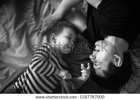 Similar – Image, Stock Photo Man reading with wife and son sleeping