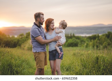 A young father and mother with their cute little daughter - Shutterstock ID 659652358