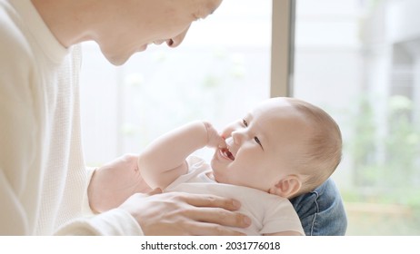 Young Father Playing With Baby