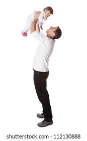 Young Father Playing With His Small Baby Daughter Holding Her Aloft With His Arms Extended Above His Head