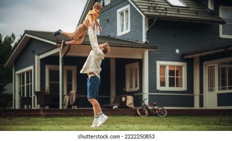 Young Father Playing with His Son Outside the House on the Front Yard. Happy Adult Man Picking Up the Excited Boy and Throwing Him Up and Down in the Air. Unconditional Love and Family Concept. - Powered by Shutterstock