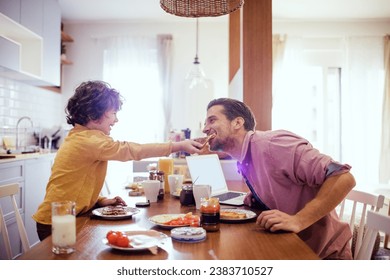 Young father and son having breakfast in the kitchen - Powered by Shutterstock