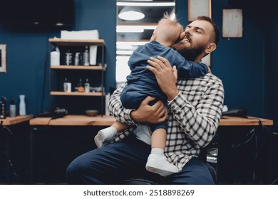 Young father supporting his little son before haircut at barber shop. Concept lifestyle dad and child boy barbershop. - Powered by Shutterstock