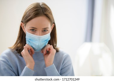 young female adjusting face mask - Powered by Shutterstock