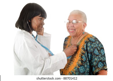 Young Female African American Nurse Or Doctor Checking Elderly African American Woman's Heart, Isolated On White.